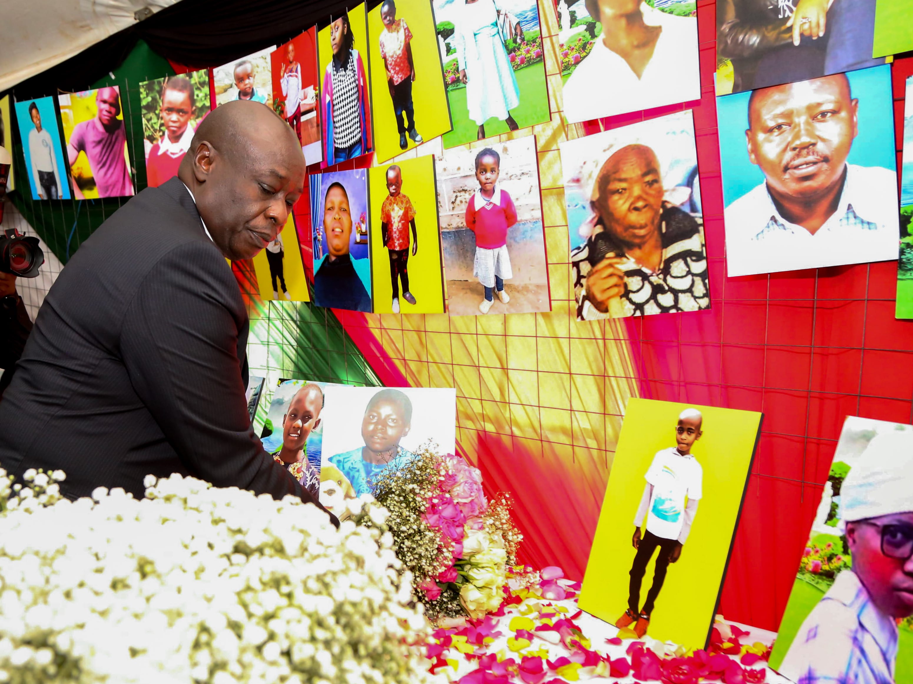 Laying flowers on the table of portraits of the Maai Mahiu flood victims 