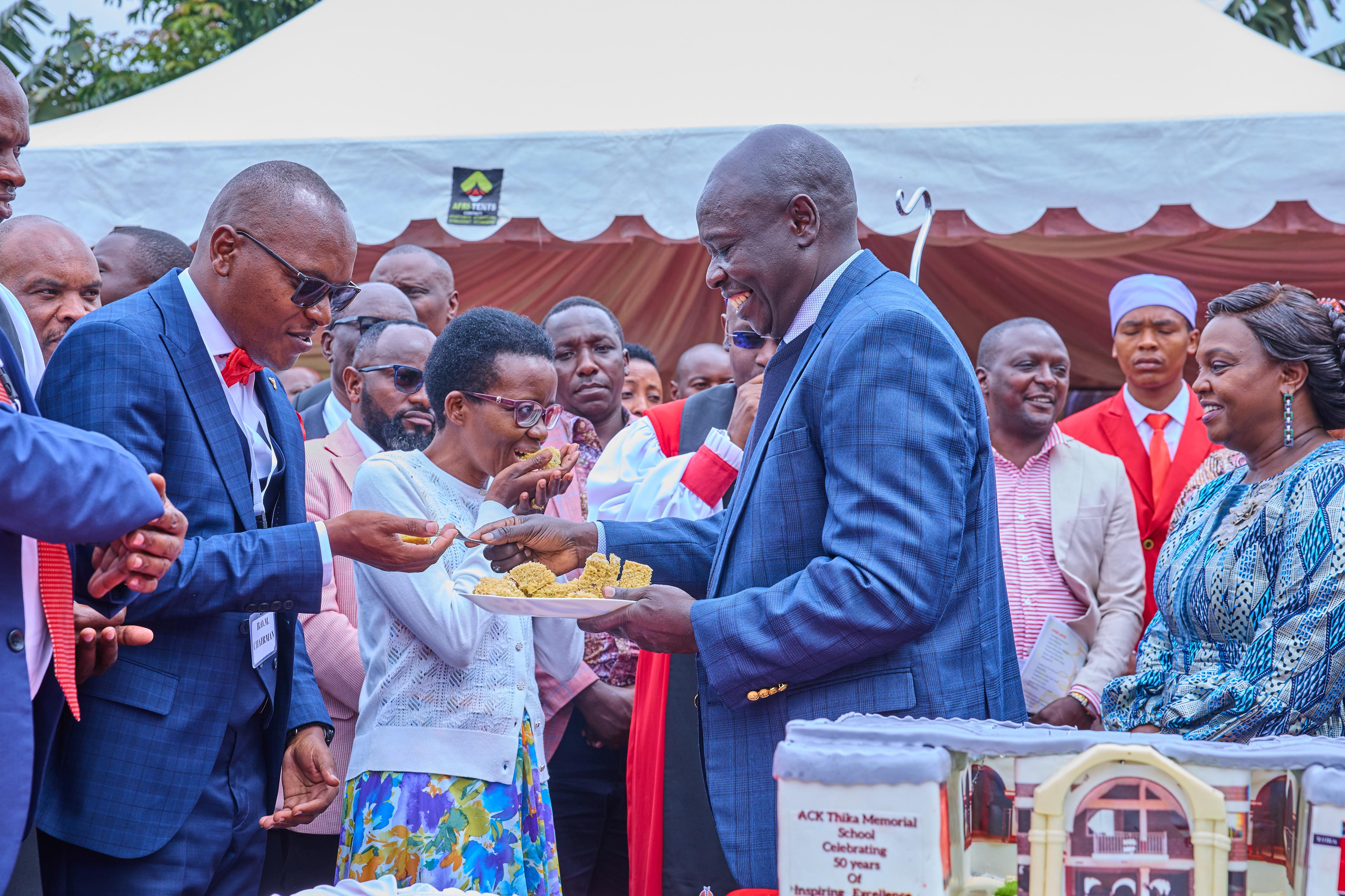 Deputy President Rigathi Gachagua and his wife Pastor Dorcas Rigathi share cake with congregants  during Golden Jubilee celebrations of ACK Thika Memorial Church School in Gatanga Sub-County, Murang'a County, on August 2, 2024.